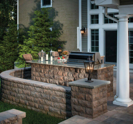 Patio fireplace, wall seating and post lamp on wall block
